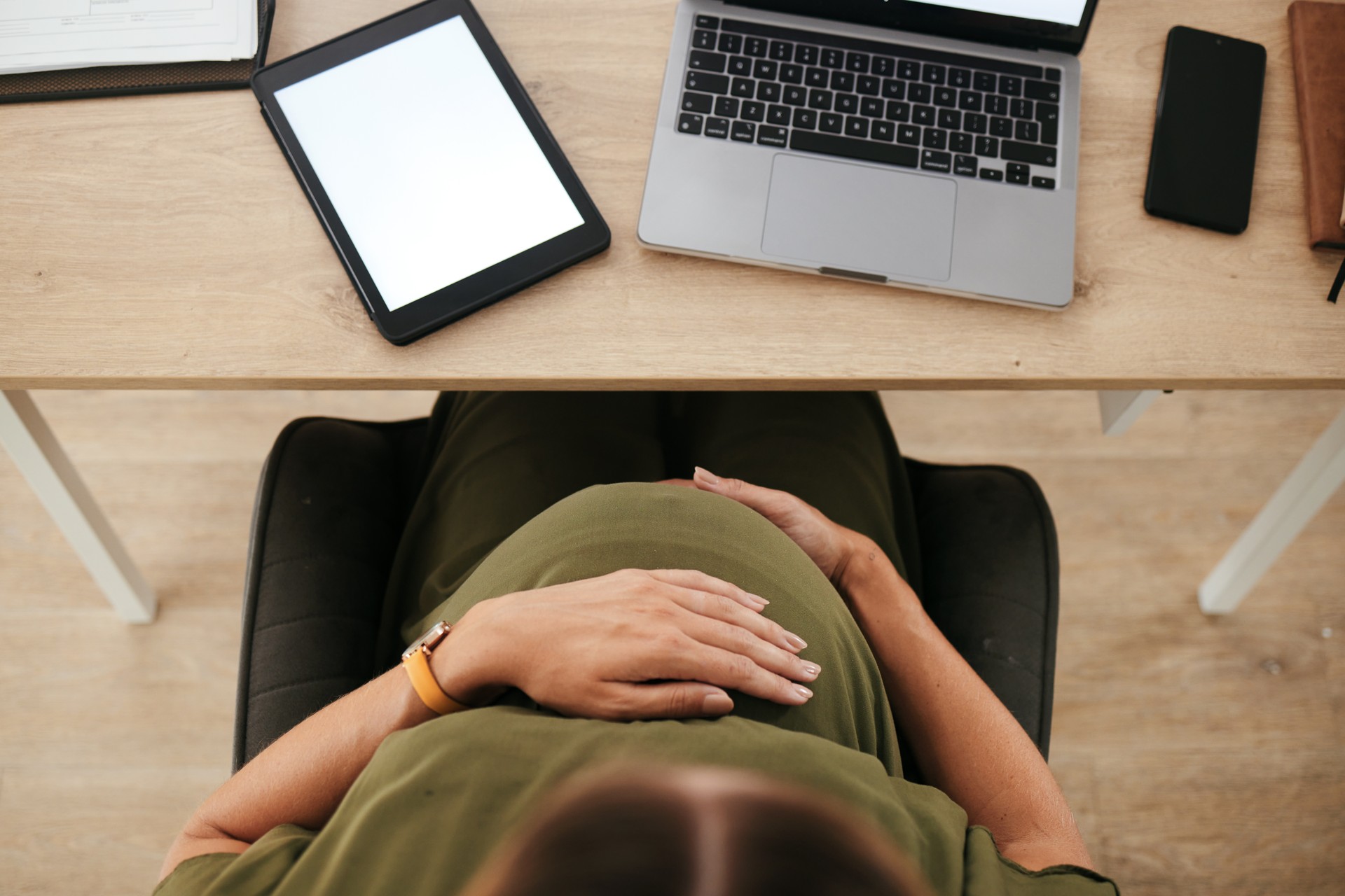 Woman, pregnant and stomach with tablet screen in space with mockup for digital marketing by top view.vFemale entrepreneur, person and technology for website, homepage and about us for e commerce