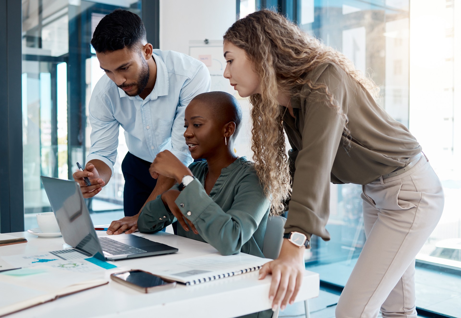 Team collaboration, online marketing and laptop planning for ideas, inspiration and strategy in startup company. Business people in diversity group working, meeting and discussion with internet tech